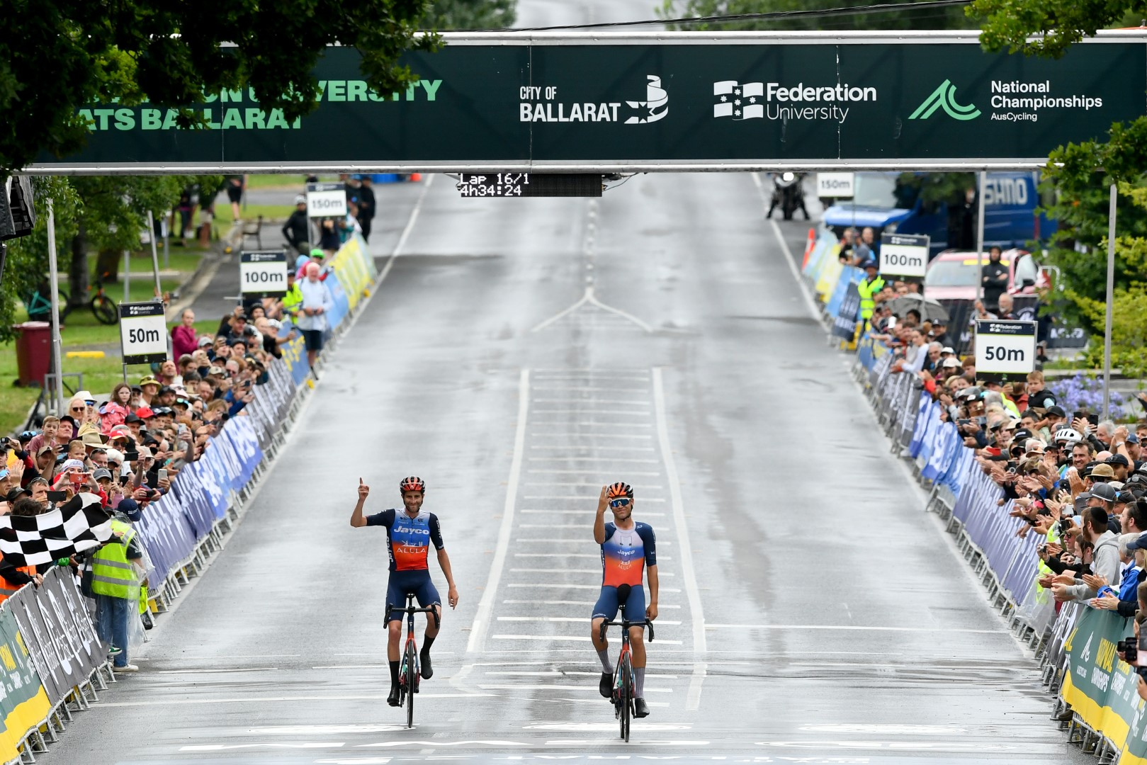 Lucas Plapp and Chris Harper cross the finish line together at the 2024 AusCycling Road Race National Championships in Buninyong, Ballarat